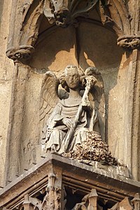 Sculpture of angel with trumpet, south portal
