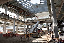A two level transit hub is currently under construction. Roof panels, walls, stairs, and concrete have not been completed yet.
