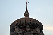 sculpture of lion projecting from the main spire of the temple