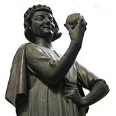 Statue of man holding apple.
