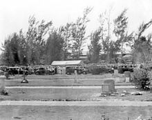 Image at a cemetery showing a burial ceremony