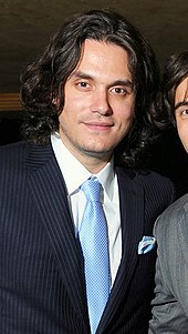 The singer John Mayer wearing a pinstripe jacket and a necktie