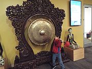 Child (John) banging a "Gong" in the Experience Gallery.