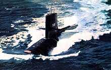 Colour photograph of a submarine underway after surfacing