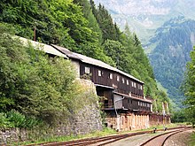 Wooden warehouse buildings over a railway track