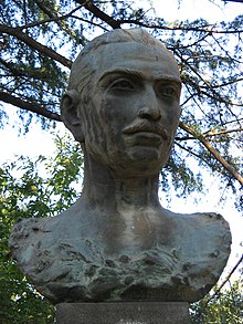 Bust of Vitaliano Brancati with tree branches in background