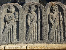 Three of the bas-reliefs depicting the apostles at the base of the cross