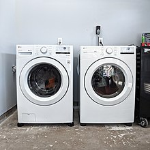 A picture depicting two front-loading washing machines.