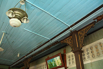 Ceiling with old chandelier and decorative brackets