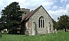 A stone church with a tower just visible at the far end