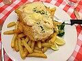 Surf and turf schnitzel: a chicken schnitzel topped with prawns and served with french fries