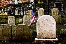 Headstone with an American Flag to the left