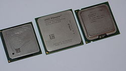 Side-by-side comparison of AMD (center) and Intel (sides) integrated heatspreaders (IHS) common on their microprocessors