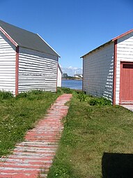 The churh view from the wooden sidewalk and stores of the patrimonial site, on the sea shore