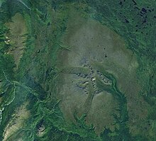 Landscape of a vegetated plateau with rivers and mountains.