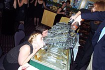 Party goers drinking from ice luges (2003)