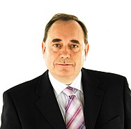 A close-up image of Alex Salmond, a round-faced middle-aged man with short black hair and a pink tie