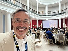 Domenico Grasso poses for a selfie at the Michigan Alumni Association Board of Directors meeting.