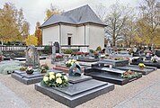 Building where ceremonies take place. Foreground: the grave of Lucien Wercollier.