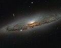 NGC 4845's glowing centre hosts a gigantic version of a black hole.[9]