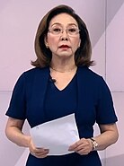 An image of Mel Tiangco holding a paper.