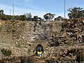 Composite photo showing tail of XPT train entering tunnel and (2) disappearing left, 30m higher 2 minutes later