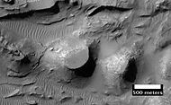 Close up of layers in eroded deposits on the floor of Bouguer Crater, as seen by HiRISE. This image is in a different part of the crater than the CTX image to the right.