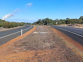 A dual carriageway road photographed from the median strip