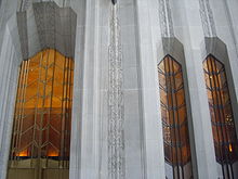 A series of tall windows at 1 Wall Street. Between each window are limestone piers.