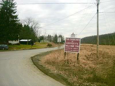 Sign for the churches of Grover, Pennsylvania as seen at a turn from State Route 154 in February 2012