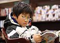 Young boy reading manga