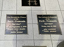 two black plaques on grey tiled floor