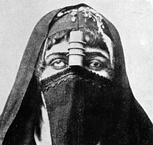 Black and white person wearing mask