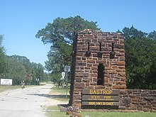 A road passing through a stone entrance in the grasslands