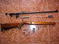 A TOZ-17 cadet rifle chambered for .22 long rifle which has been disassembled. The bolt is locked by the bolt handle being dropped into a notch in the receiver.