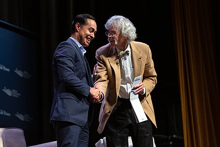 Art Cullen greets Julian Castro on stage at the Heartland Forum in Storm Lake, Iowa