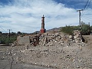 Charred and derelict pit of a former home