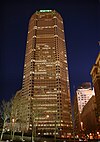 A tall beige building with the word "Mellon" in glowing green letters on the top.