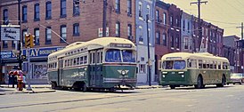 A PCC-type trolley and a Brill trackless trolley of PTC, wearing the company's standard paint scheme of green-and-cream in 1968 at 7th Street & Snyder Avenue