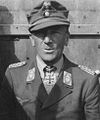 A man wearing a military uniform with an Iron Cross displayed at the front of his uniform collar.