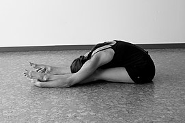 Caterpillar pose, the Yin version of Paschimottanasana: in Yin Yoga, poses are held for an average of five minutes to improve flexibility and restore a fuller range of motion.[35]