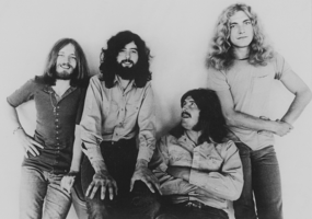 A photoshoot of the band Led Zeppelin in front of a white wall