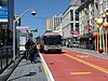 A bus stop with bus in the median of an urban arterial