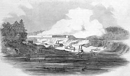 Black and white drawing show gunboats in a river and a fort in the background.