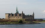 Kronborg Castle, a fortified brick structure, seen from a distance.