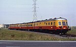 A preserved diesel-hydraulic locomotive and train on an excursion trip through the port of Antwerp in 1992