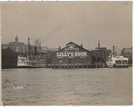 This picture, also dated circa 1907, shows just Dock C. I'd make a strong guess that this is later rather than earlier compared to the picture on the hand-colored postcard, and it shows different text on the end of the pier shed: "Pier C"; the diamond is there, but the Maltese cross seems to have been painted over; "Columbia & Puget Sound R.R.", "Lilly's Dock".