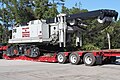 Rear view of a Lowboy trailer manufactured by Talbert loaded with a Link-Belt Lattice Crawler crane.
