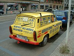 Yellow station wagon with advertising