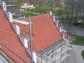 A church roof under repair with terracotta tiles